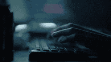 Man typing inconspicuously on his computer.