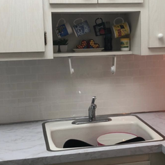 reviewer photo of same kitchen with new white subway tile adhesive 