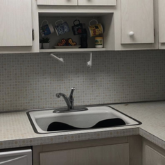 reviewer photo of kitchen with outdated backsplash 