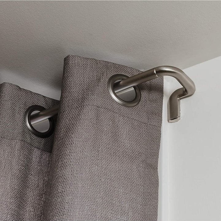 the curved silver curtain rod 
