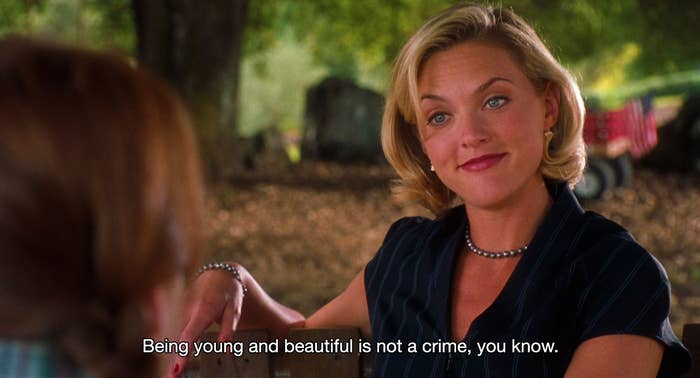 Meredith sitting on a bench, staring at Hallie with attitude, saying: &quot;Being young and beautiful is not a crime, you know&quot;