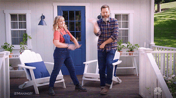 Amy Poehler and Nick Offerman dancing on a porch 