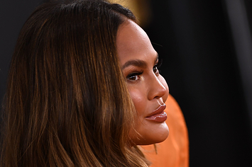 Chrissy Teigen poses for a photo at a red carpet event
