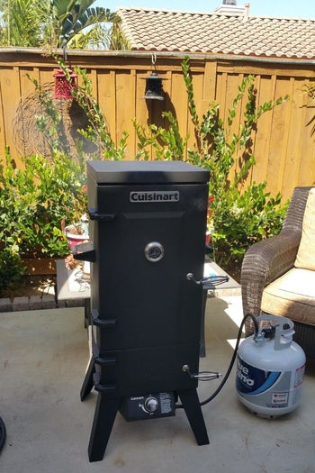 The Cuisinart vertical smoker in an outdoor patio.