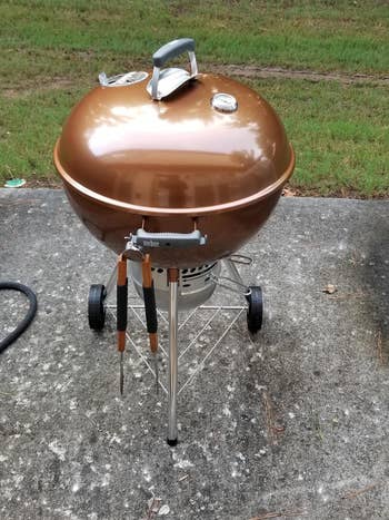 A reviewer's gold colored Weber charcoal grill