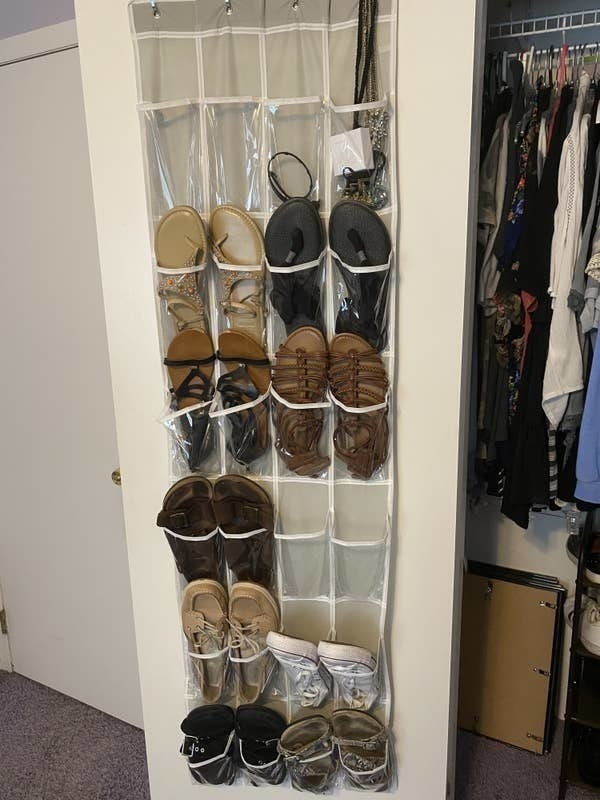 BuzzFeed Editor Samantha Wieder&#x27;s over-the-pocket organizer holding shoes like sandals, lightweight sneakers, and slip-on shoes — each pocket holds one shoe