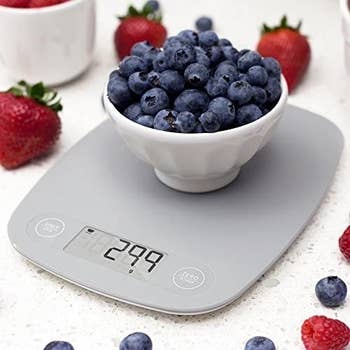 The scale with a bowl of blueberries on top
