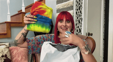 A gif of someone holding up the Colortone Tie Dye T-shirt in Reactive Rainbow.