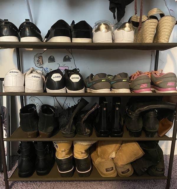 BuzzFeed Editor Samantha Wieder&#x27;s shoe rack with three tears holding heavier shoes like boots and running sneakers