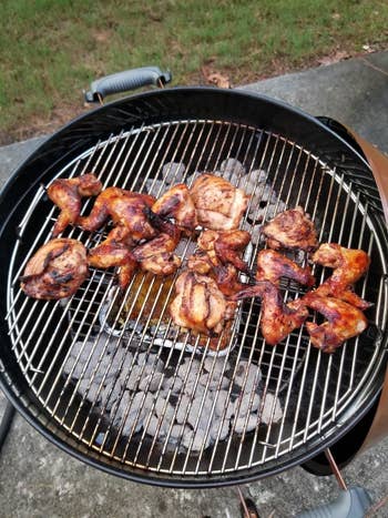 Barbecue chicken wings cooking over charcoal on the reviewer's  Weber grill