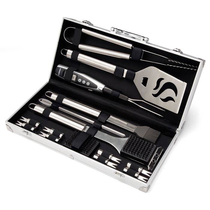 A set of grilling tools including a basting brush, cleaning brush, and tongs, in a protective case.