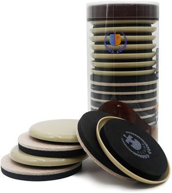 A stack on round furniture sliders in and out of their packaging
