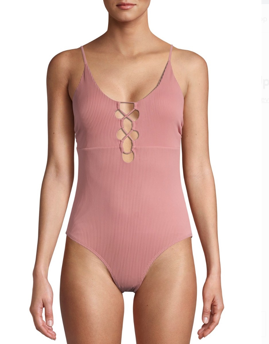 A model in a pink ribbed one-piece 