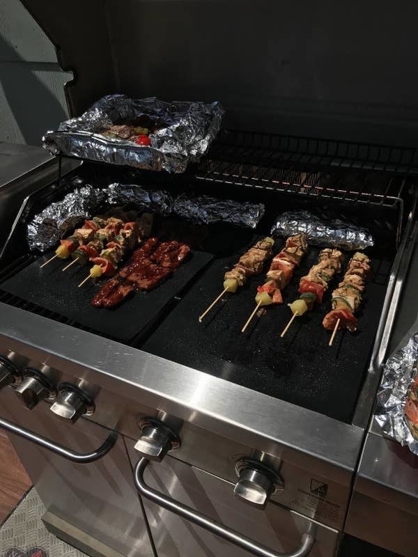 A reviewer photo of their barbecued food on top of the grill mats on the grill