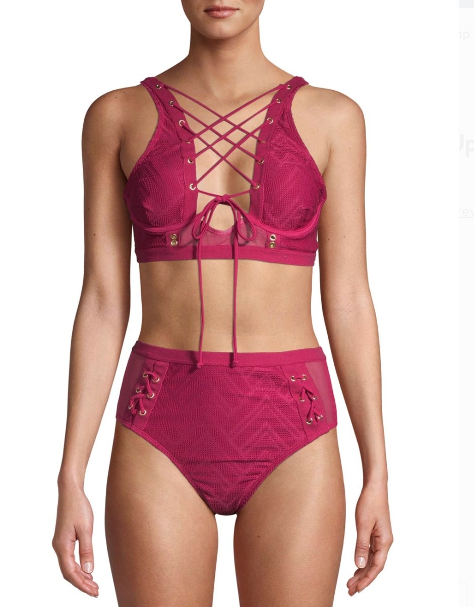 A model in a lace up pink bikini 