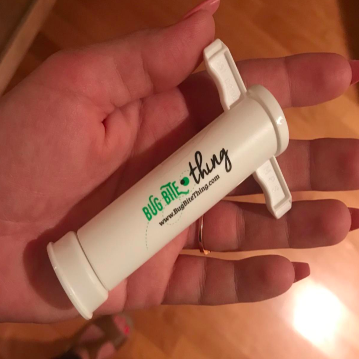 A reviewer holding the bug bite suction tool