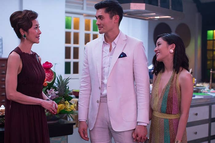 Michelle Yeoh as Eleanor talking to her son Nick (Henry Golding) and his girlfriend Rachel (Constance Wu) at a party.