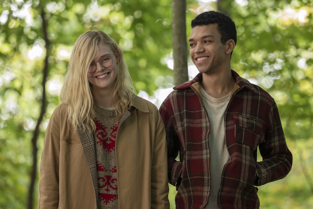 Elle Fanning as Violet smiles and walks side-by-side with Theodore (Justice Smith).