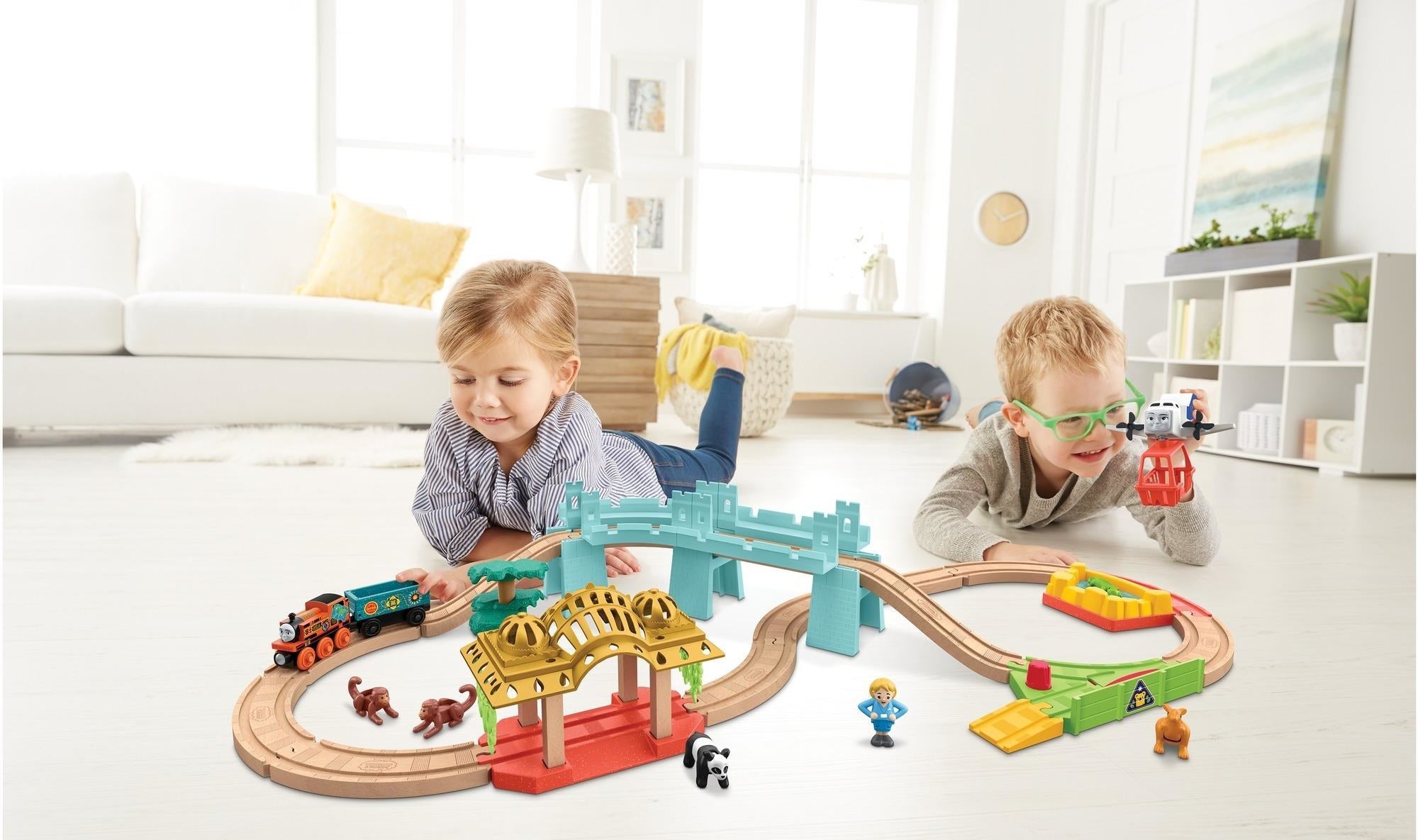 two kids playing with the train set