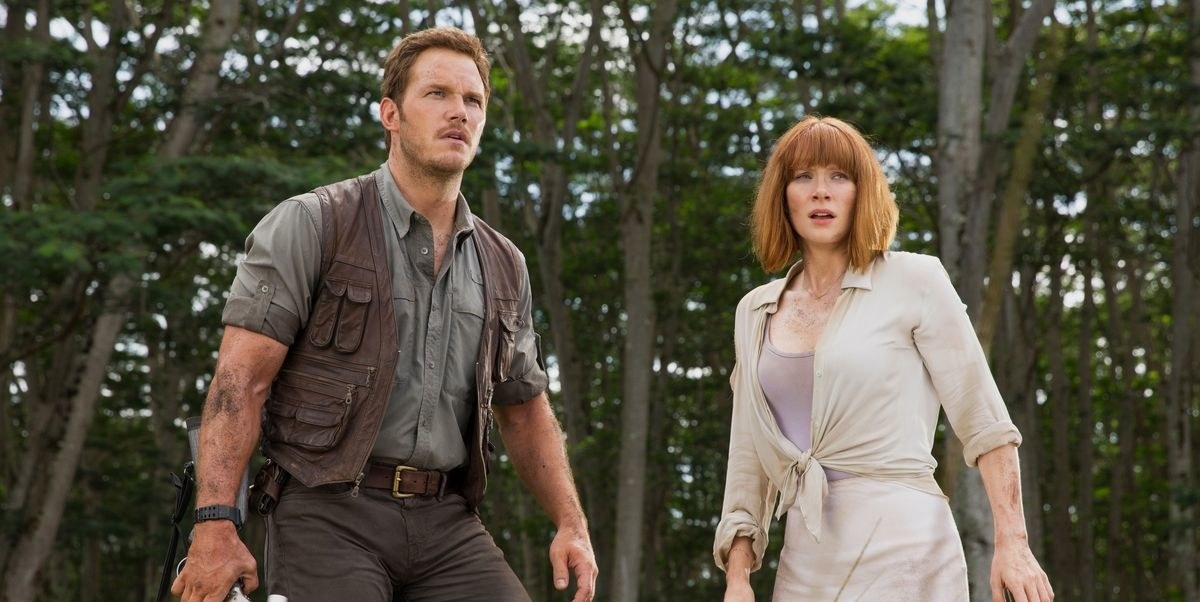 Chris Pratt as Owen and Bryce Dallas Howard as Claire looking off into the distance with fear.