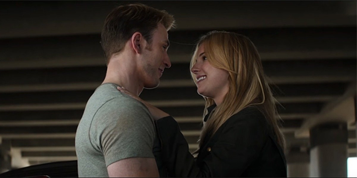 Chris Evans as Steve Rogers embraces and is about to kiss Sharon (Emily VanCamp).