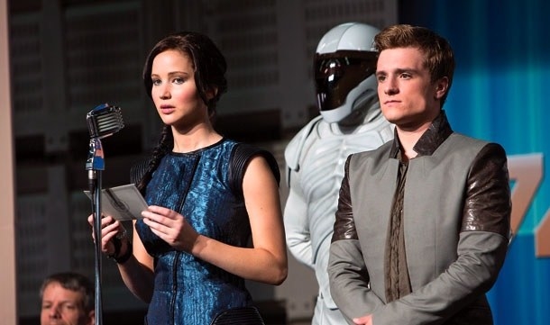 Jennifer Lawrence as Katniss makes a speech with Peeta (Josh Hutcherson) by her side. 