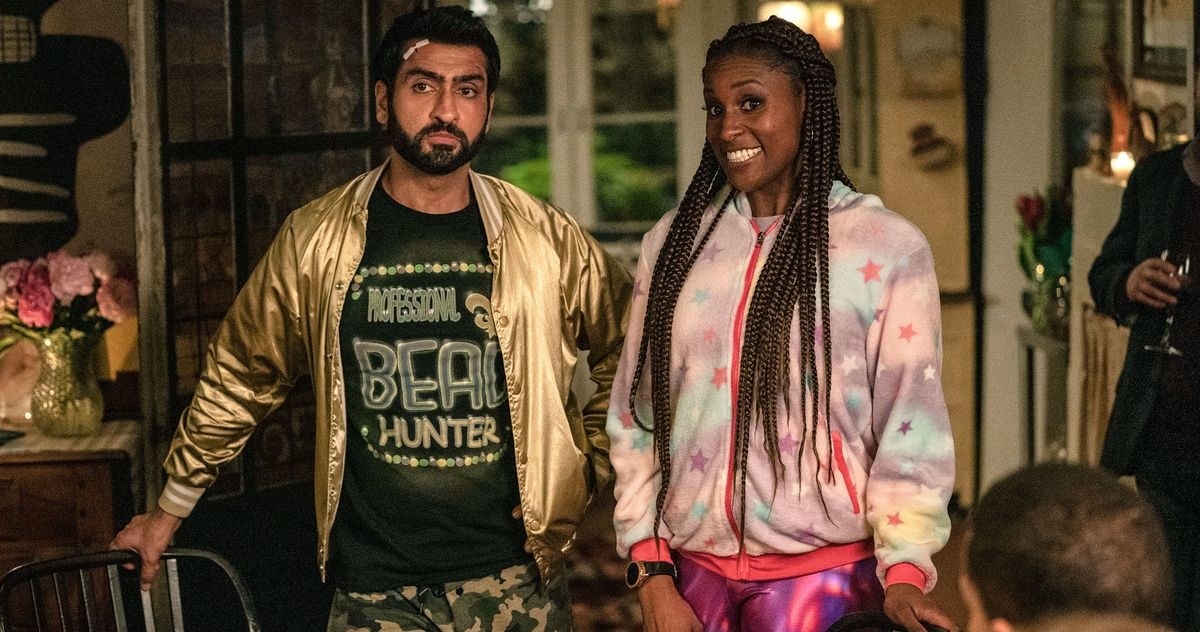 Kumail Nanjiani as Jibran stands next to a smiling Leilani (Issa Rae).