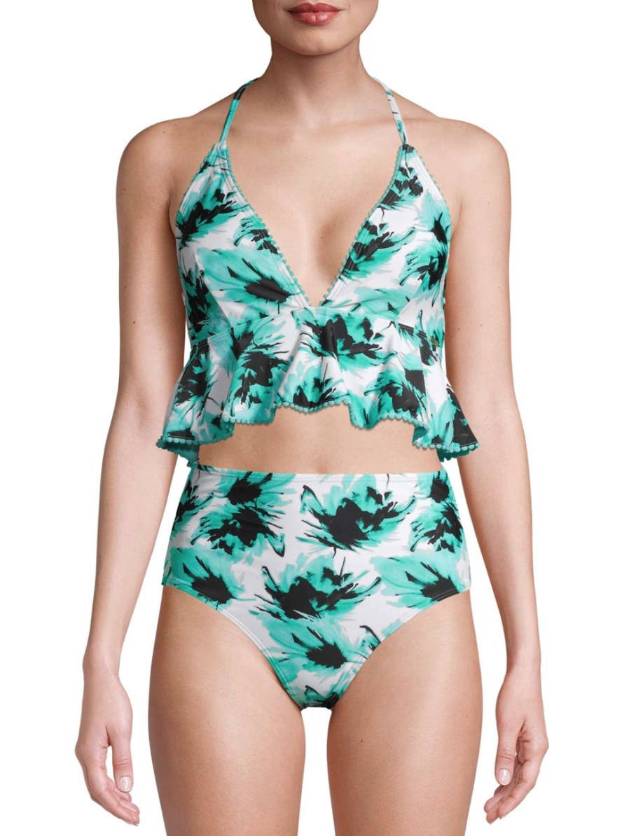 Model in a white tankini with blue floral patterns and ruffle detail