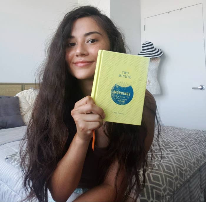 The writer holding the Two Minute Mornings journal