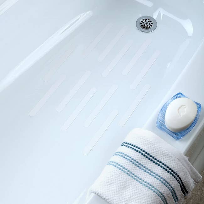 Twelve white lines placed horizontally in the tub to prevent slipping while standing in the bath
