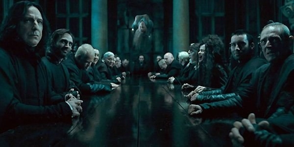 Snape, Bellatrix, the Malfoys, and the rest of the Death Eaters sitting at a long table at Malfoy Manor, listening to Voldemort give orders, while a Hogwarts teacher is being tortured to death in the air