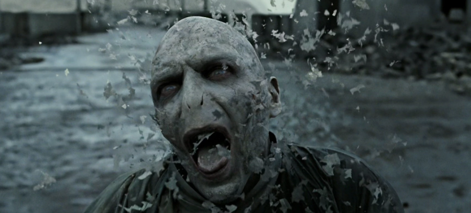 Voldemort dying towards the end of The Battle of Hogwarts, his body disintegrating, with a painful expression on his face