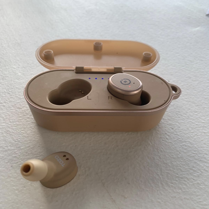 A pair of wireless earbuds in rose gold 