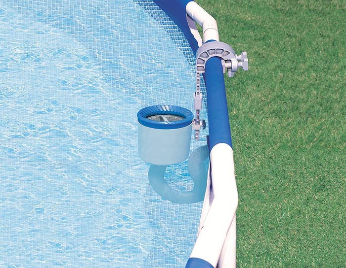 a tiny basket with a tube attached underneath along the side of a pool
