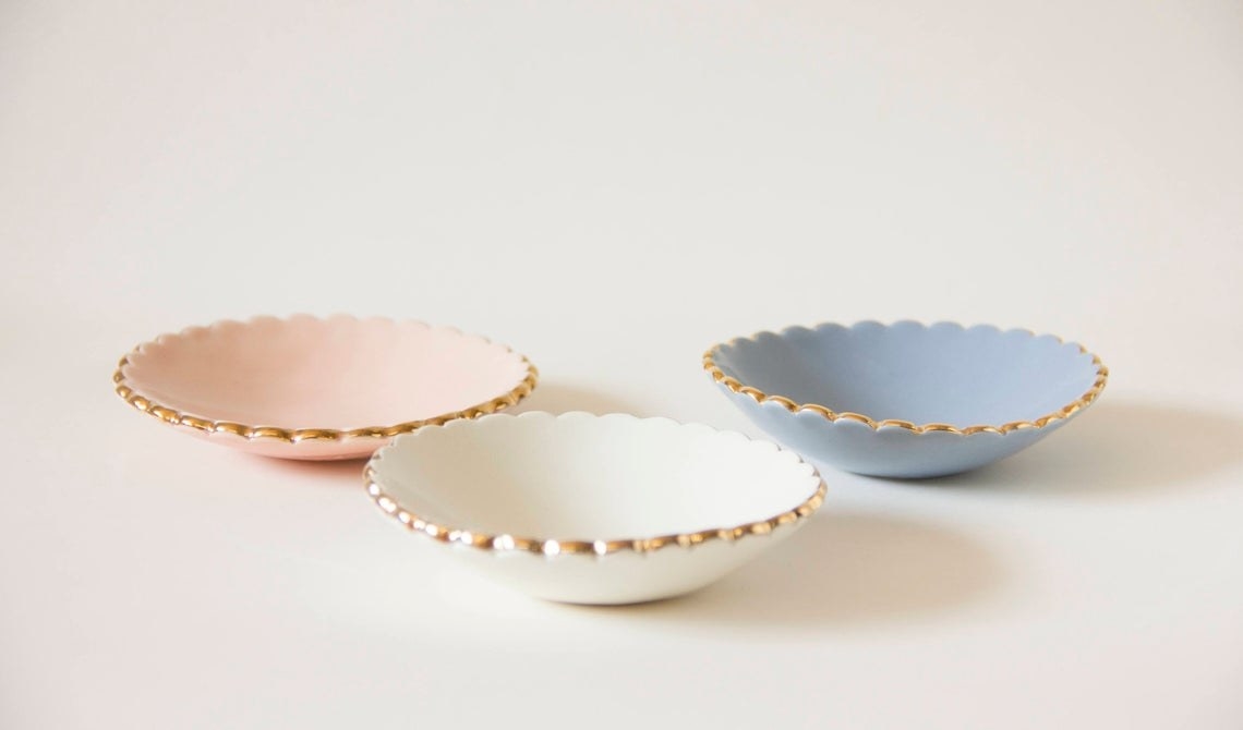 Three small ceramic ring dishes They have a rounded scallop trim