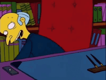 GIF of Mr. Burns from The Simpsons put a mystery box on his desk