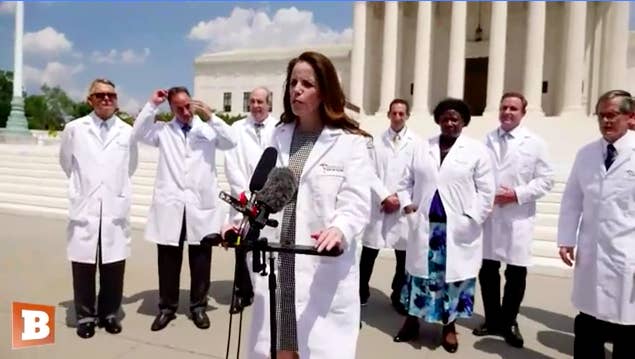 An image of people in medical gear talking in Washington as part of a video filled with coronavirus misinformation.