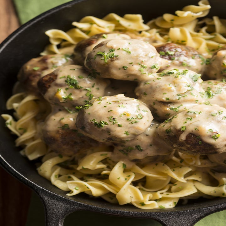 A skillet with meatballs, egg noodles, and creamy Stroganoff sauce.