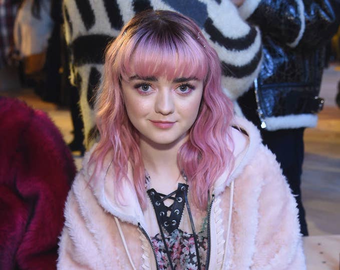 Maisie Williams front row at a fashion show.