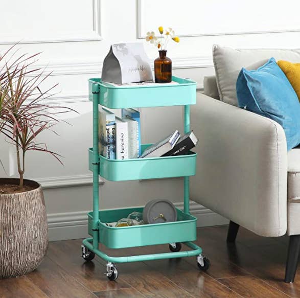 The 3-tier metal utility cart in a living room