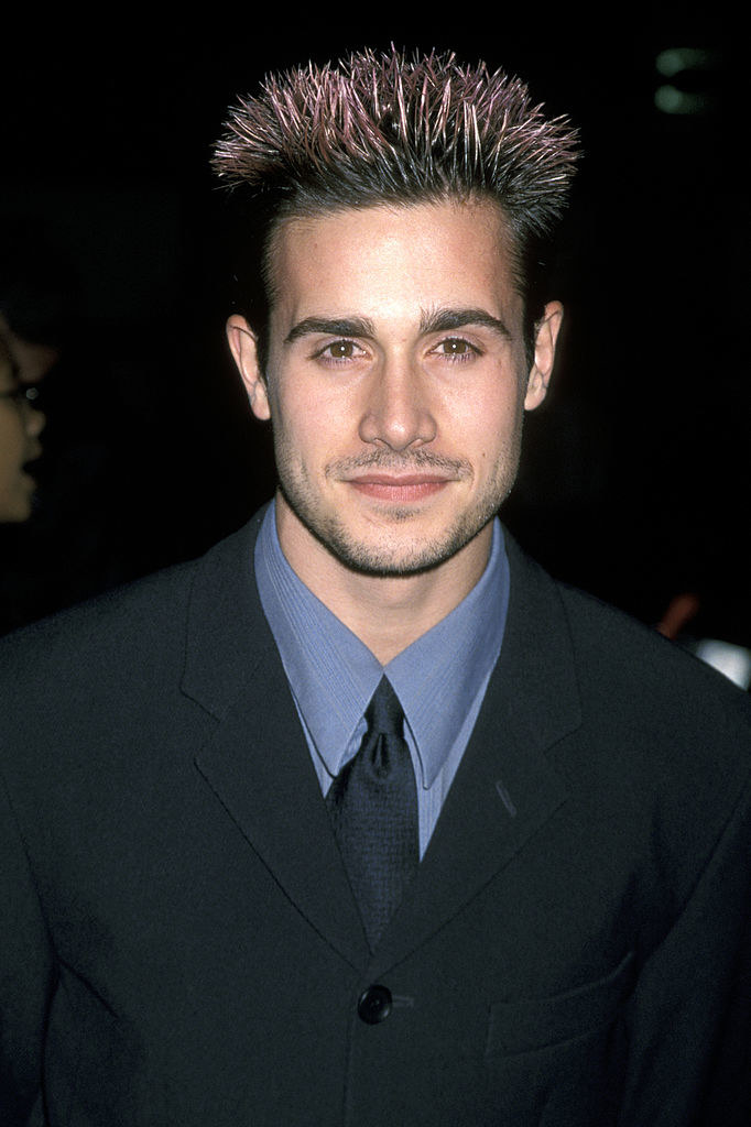 A photo of Freddie Prinze Jr. in a suit with spiky frosted tip hair.