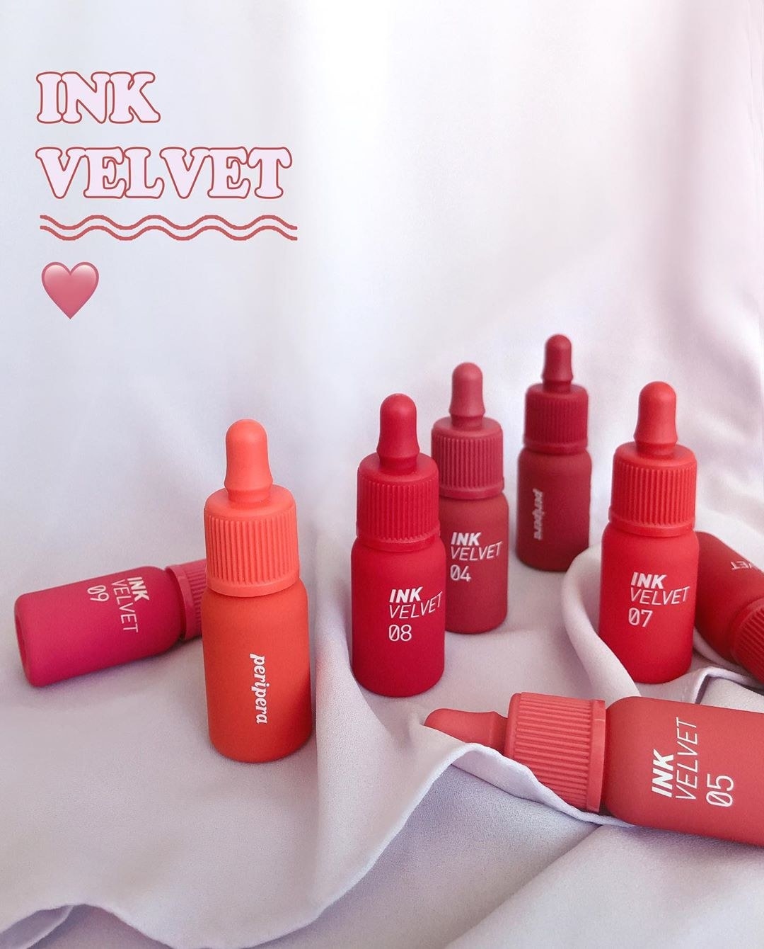 Multiple bottles of Peripera&#x27;s Ink Velvet lip stains in different red and pink shades