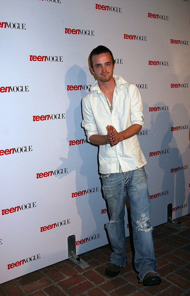 Aaron Paul on the red carpet for a Teen Vogue even wearing baggy distressed bootcut jeans and a stripped button down.