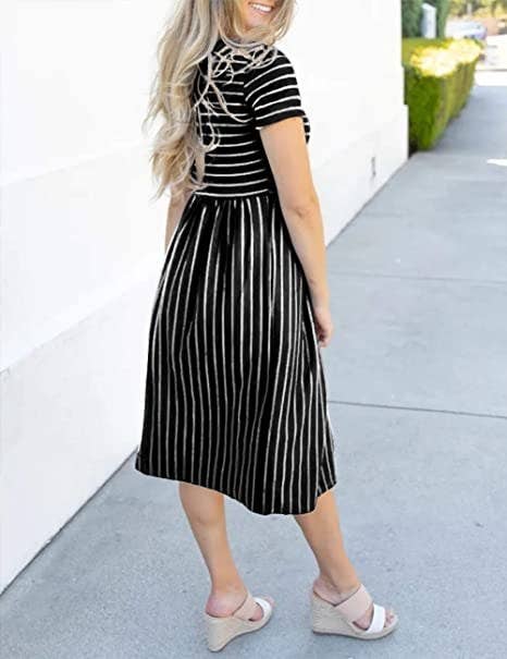 model wearing short sleeve black and white stripe dress with midi length