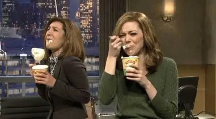 Two women are eating ice cream and crying.