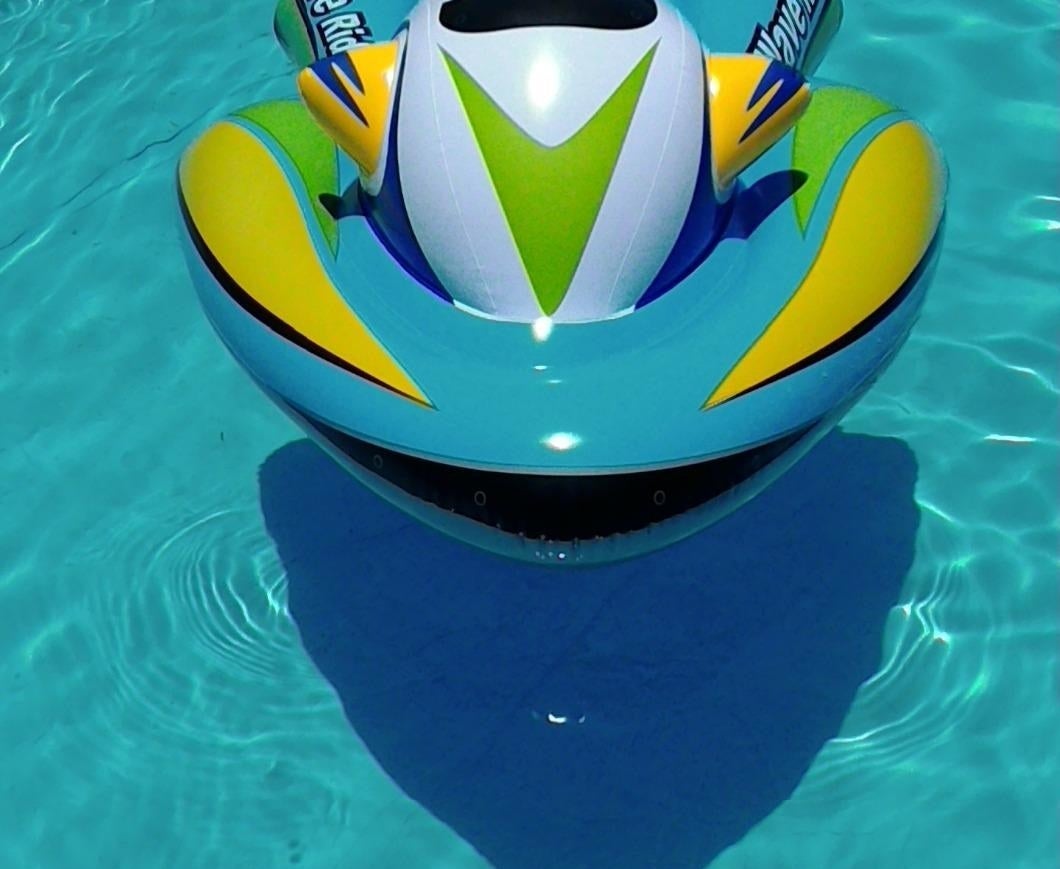 A blue, green, and yellow inflatable jet ski pool float