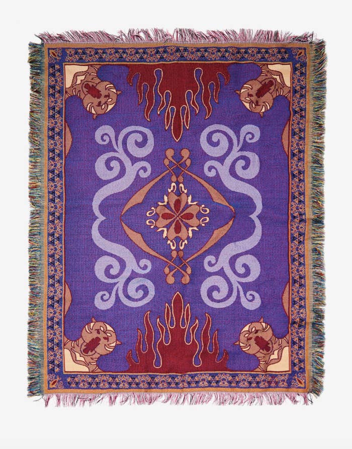a woven throw featuring a purple design with red flames, tigers, and fringed edges