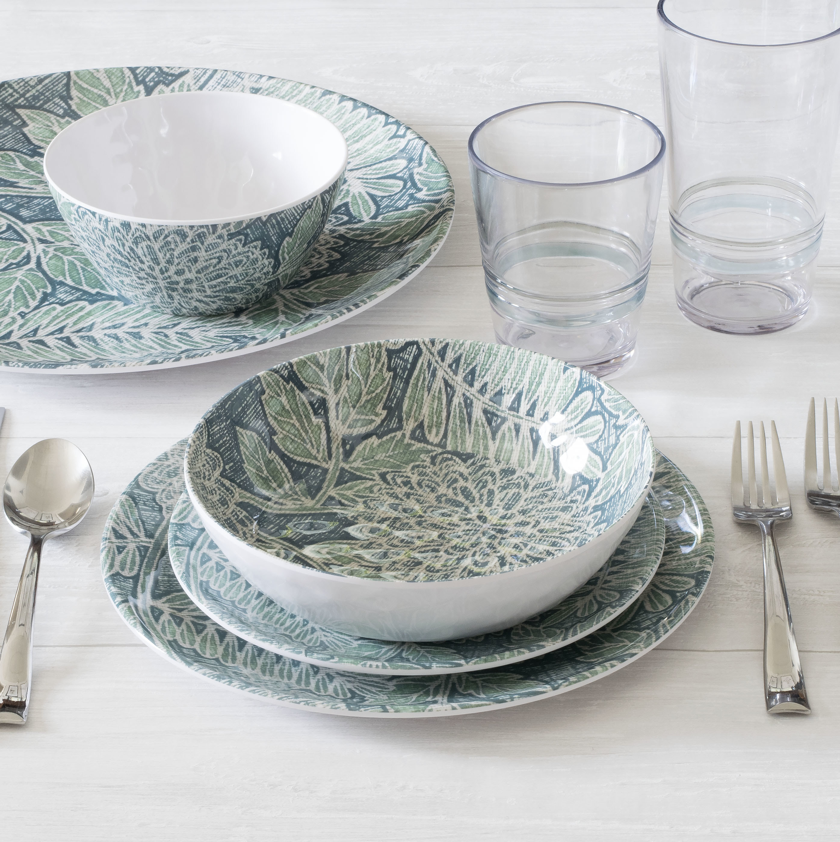 the melamine dishes and bowls with a green and blue leafy pattern inside