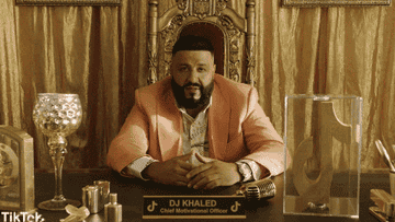 DJ Khaled is sitting at a desk, saying &quot;The sun is shining on me&quot;