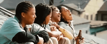 A gif from the movie Set It Off showing for black women on top of a roof laughing